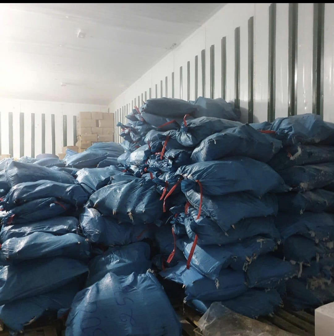 Woven bag — tied and stacked in cold store.